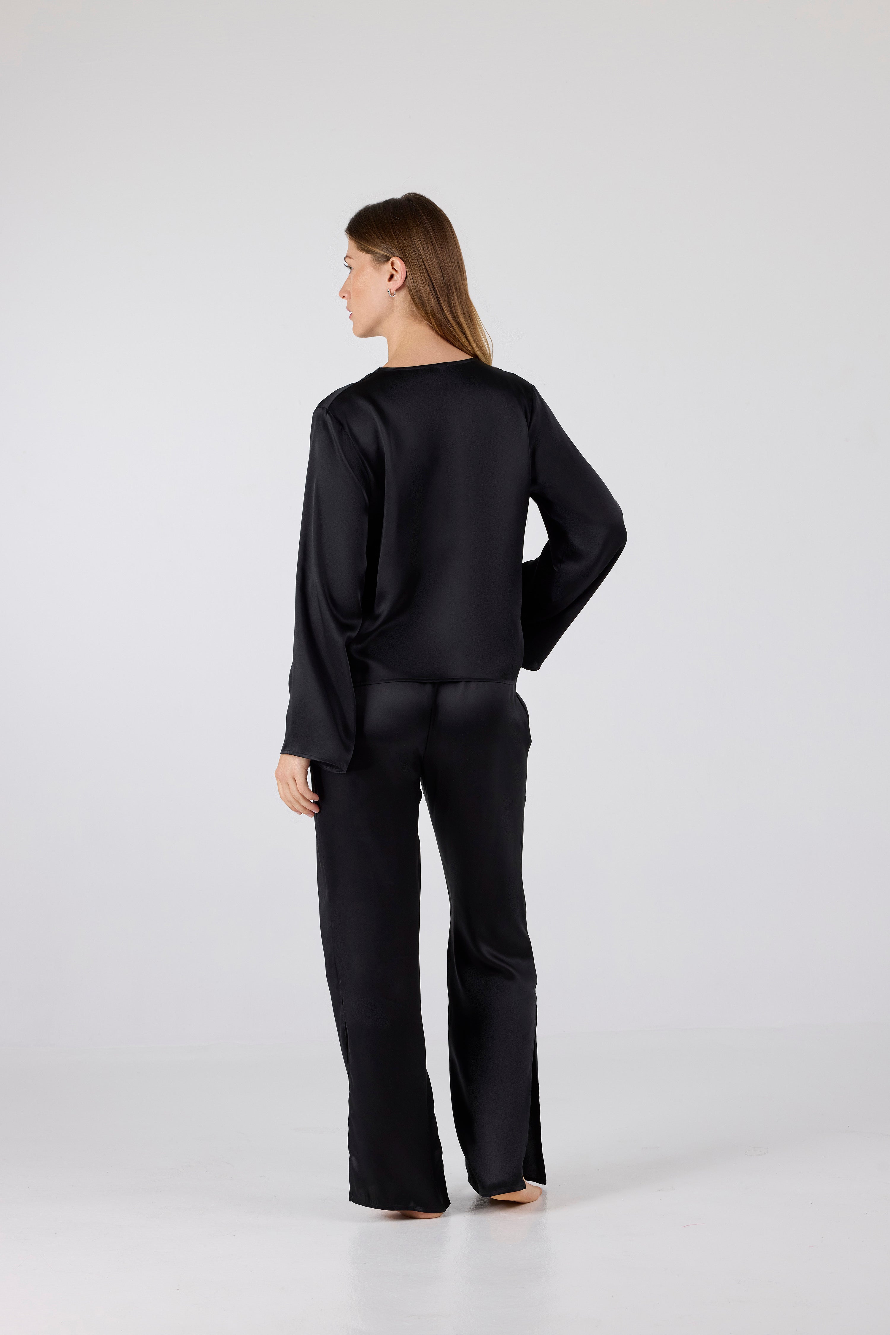 Person wearing a black outfit on a white background