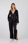 Woman wearing a black outfit on a white background