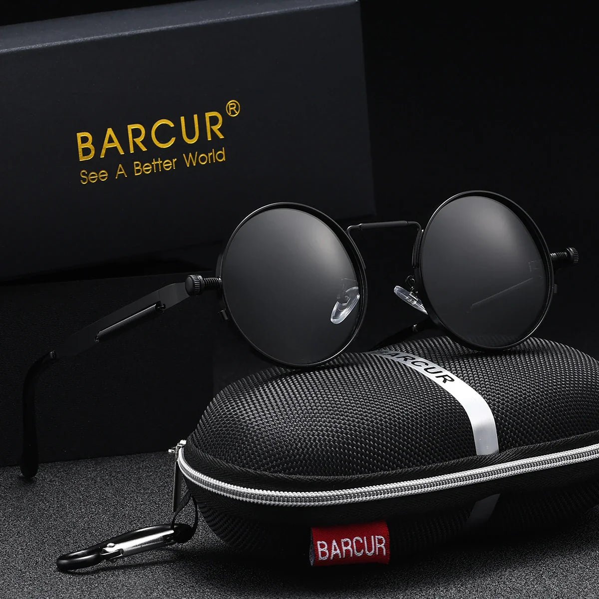 Round sunglasses with dark grey lenses and black frames, placed on a black carrying case with 'BARCUR' branding.