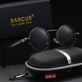 Round sunglasses with red lenses and silver frames, placed on a black carrying case with 'BARCUR' branding.
