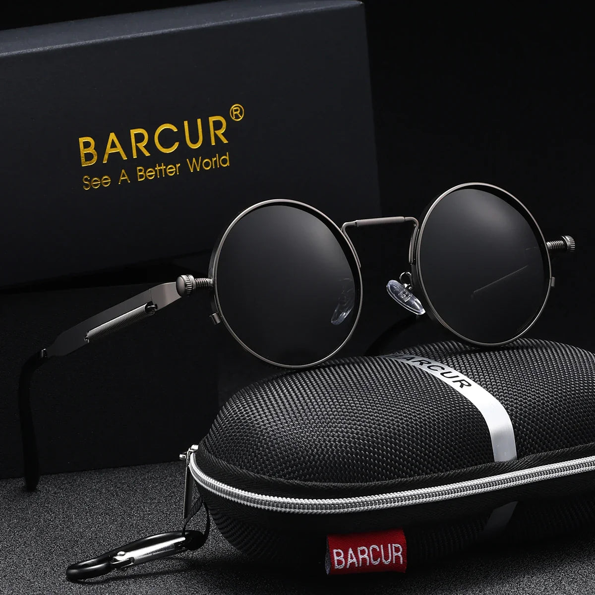Round sunglasses with red lenses and silver frames, placed on a black carrying case with 'BARCUR' branding.
