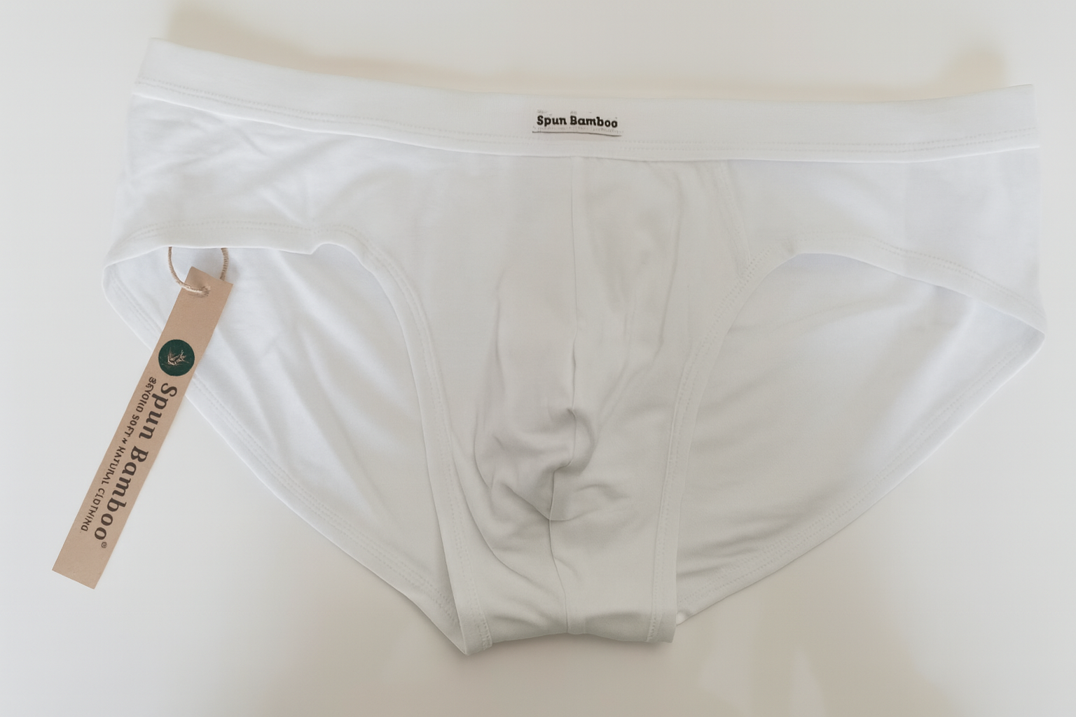 White men's underwear with a tag on a light background
