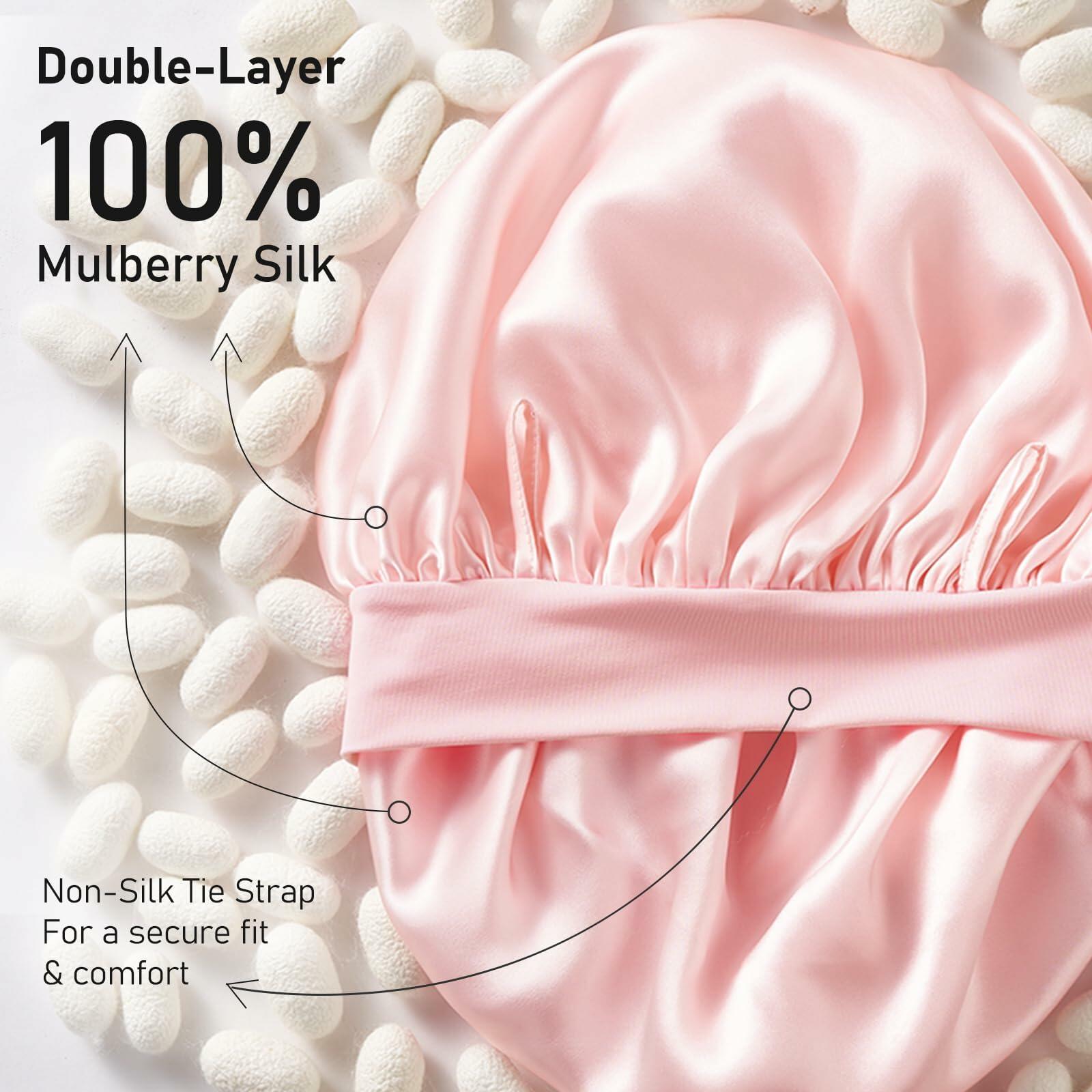 Pink satin bonnet with text highlighting double-layer 100% mulberry silk and non-silk tie strap on a white background.