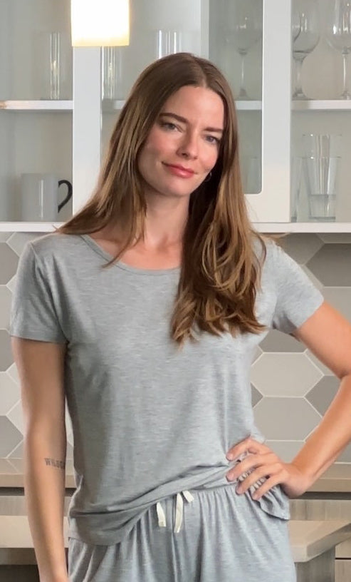 Woman wearing a gray outfit in a kitchen setting
