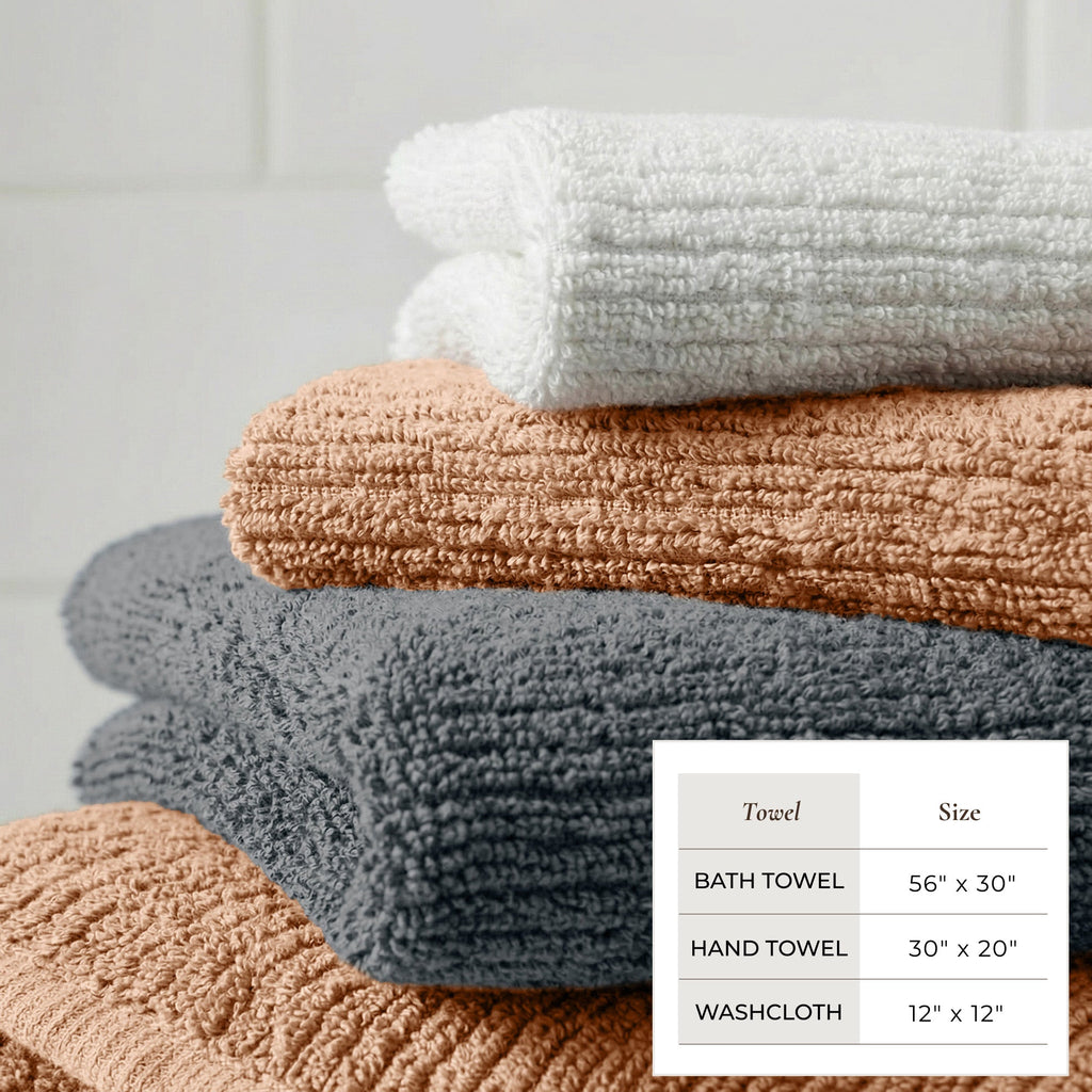 Stack of towels in various colors with size chart on a light gray background